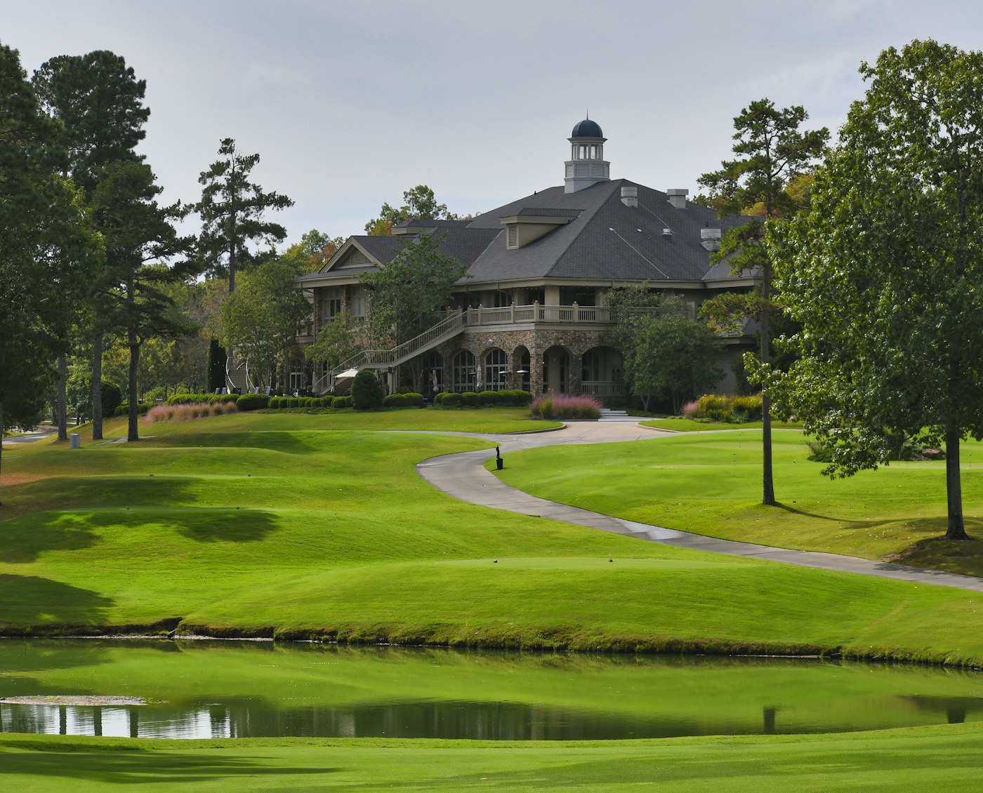 Country club house among green lawns and trees